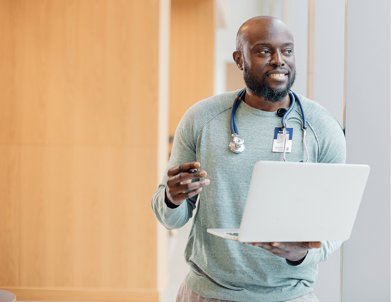 Clinician with stethoscope and laptop